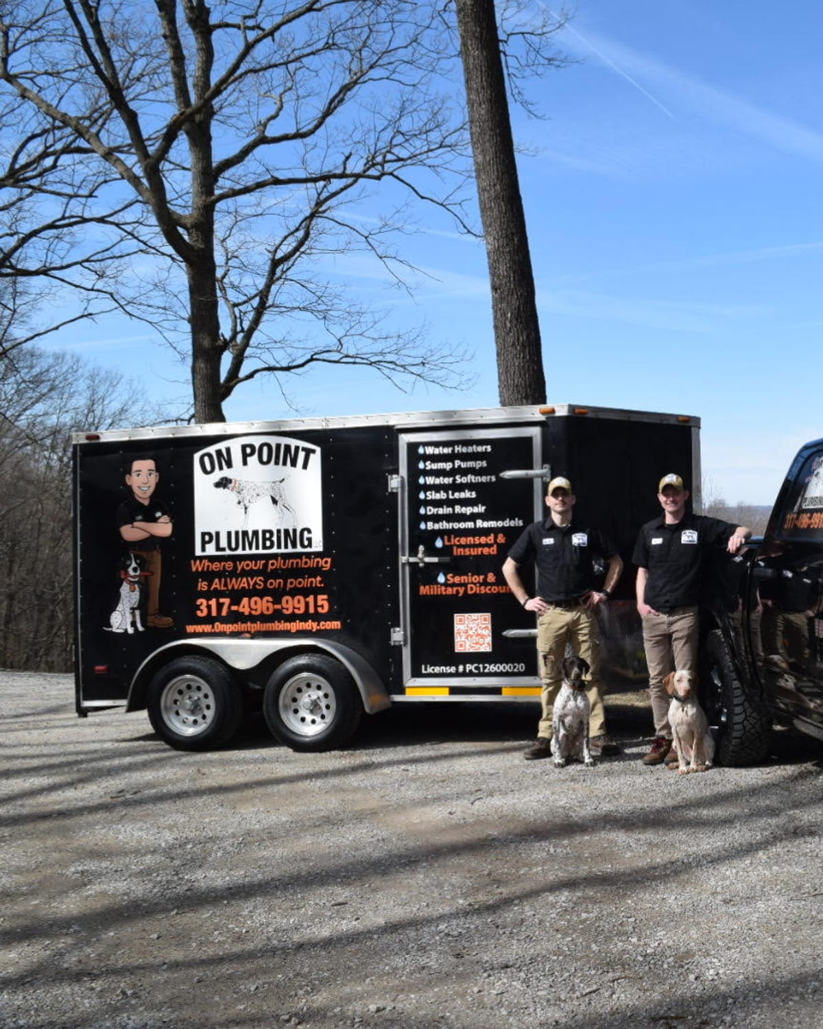 Luke and Tony of On Point Plumbing with their pointers beside the truck and trailer