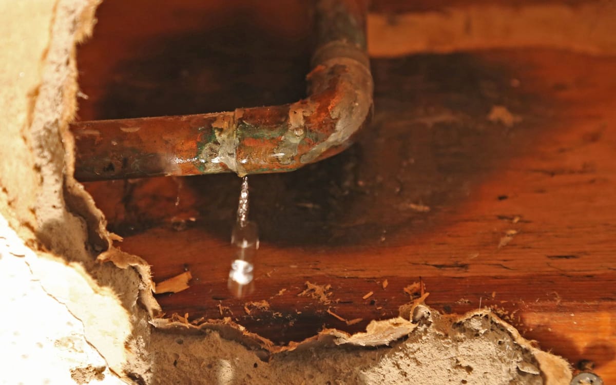 Water leaking through a ceiling from a hidden pipe failure