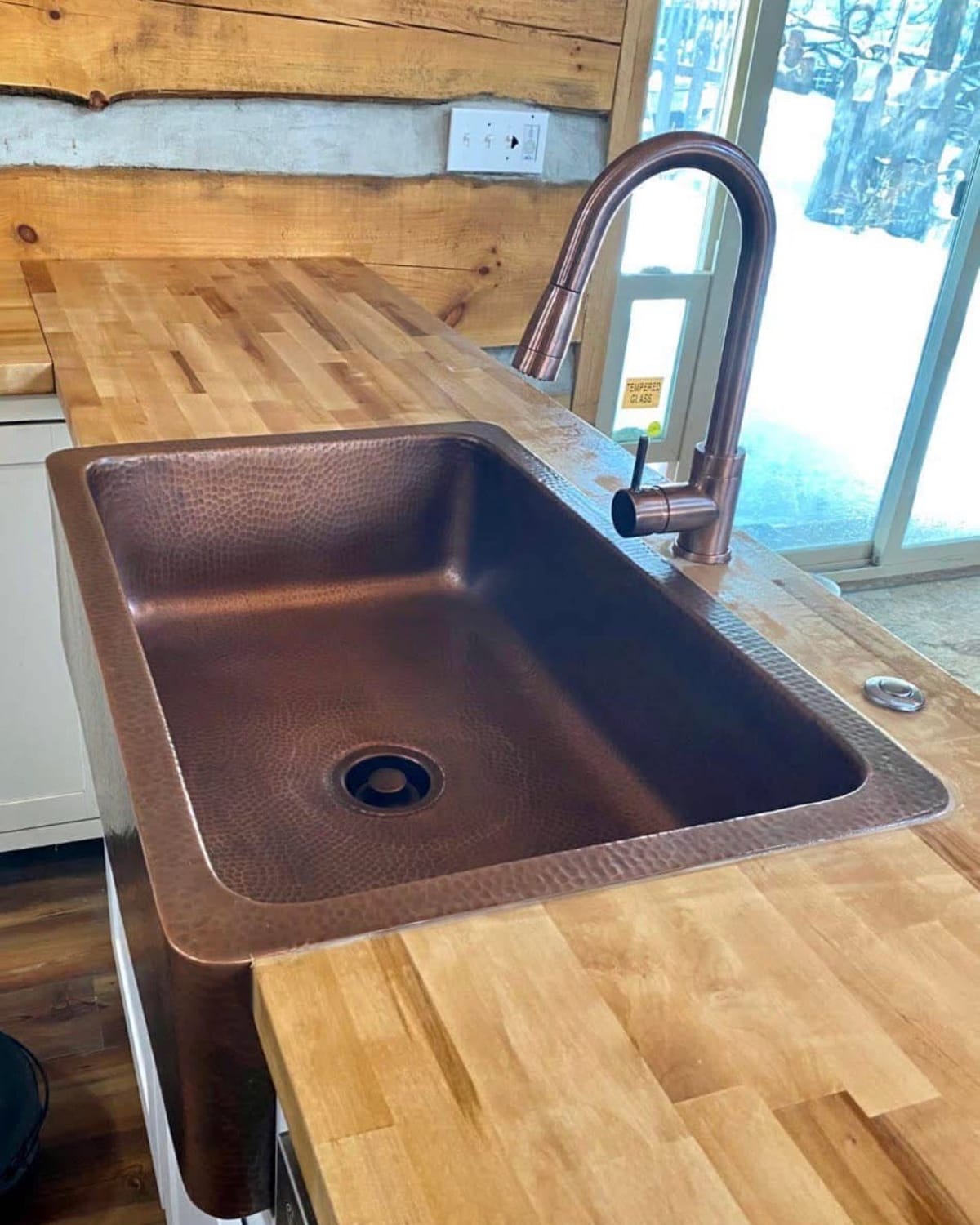 Hammered copper farmhouse sink installed by On Point Plumbing