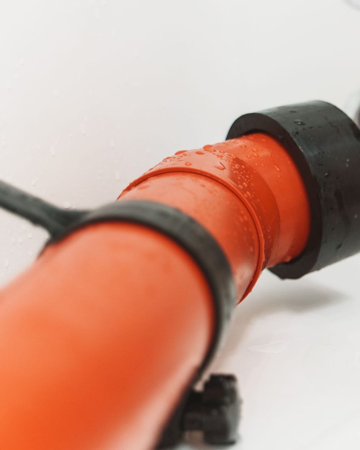 Drain cleaning spring cable entering a bathroom sink drain