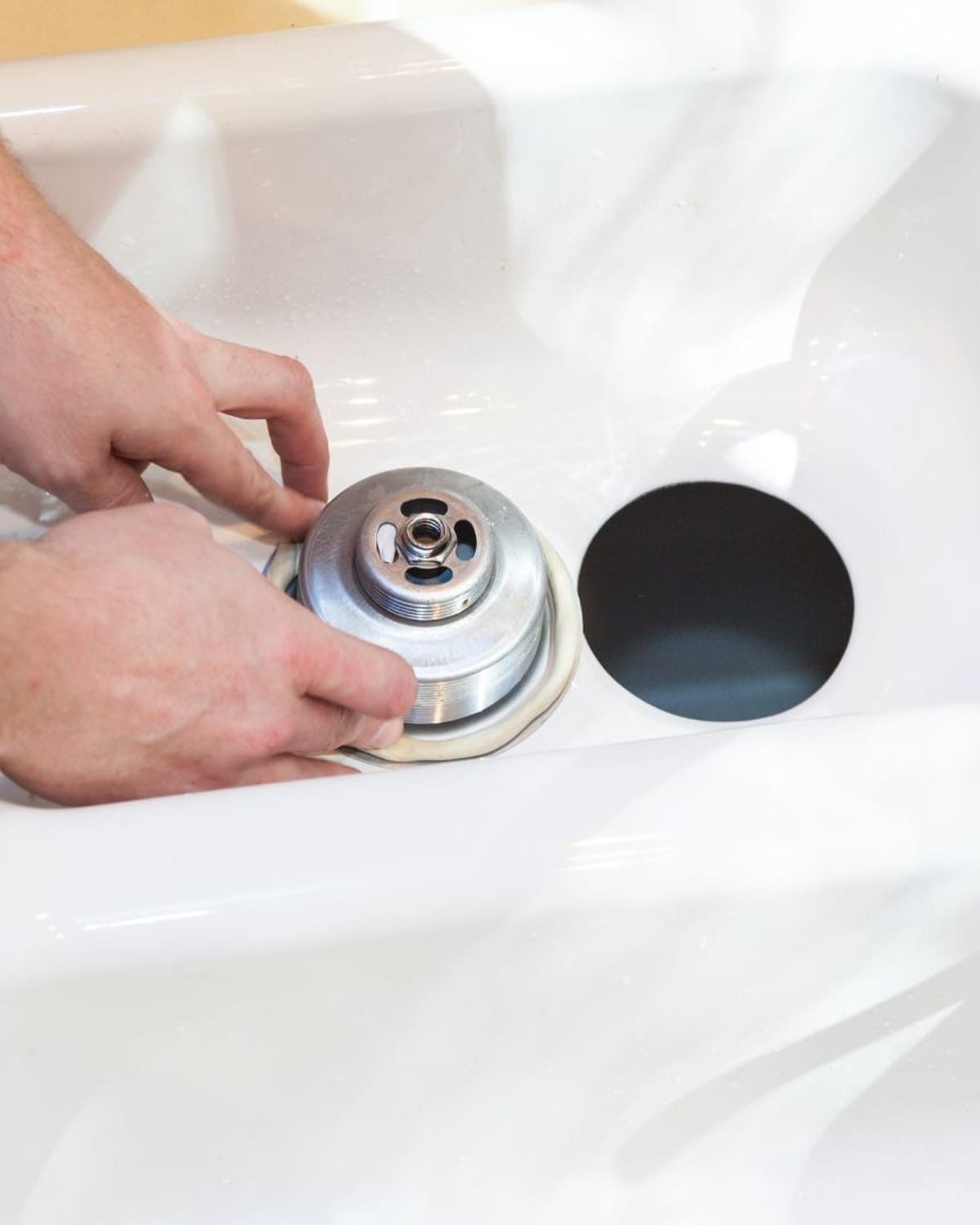 Sink drain assembly being rebuilt in a Southport home