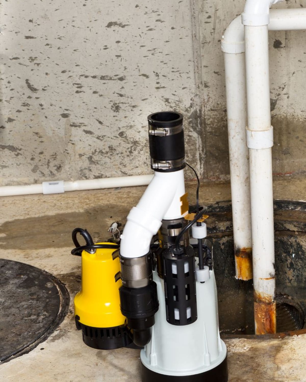 New sump pump staged beside the old unit it's replacing