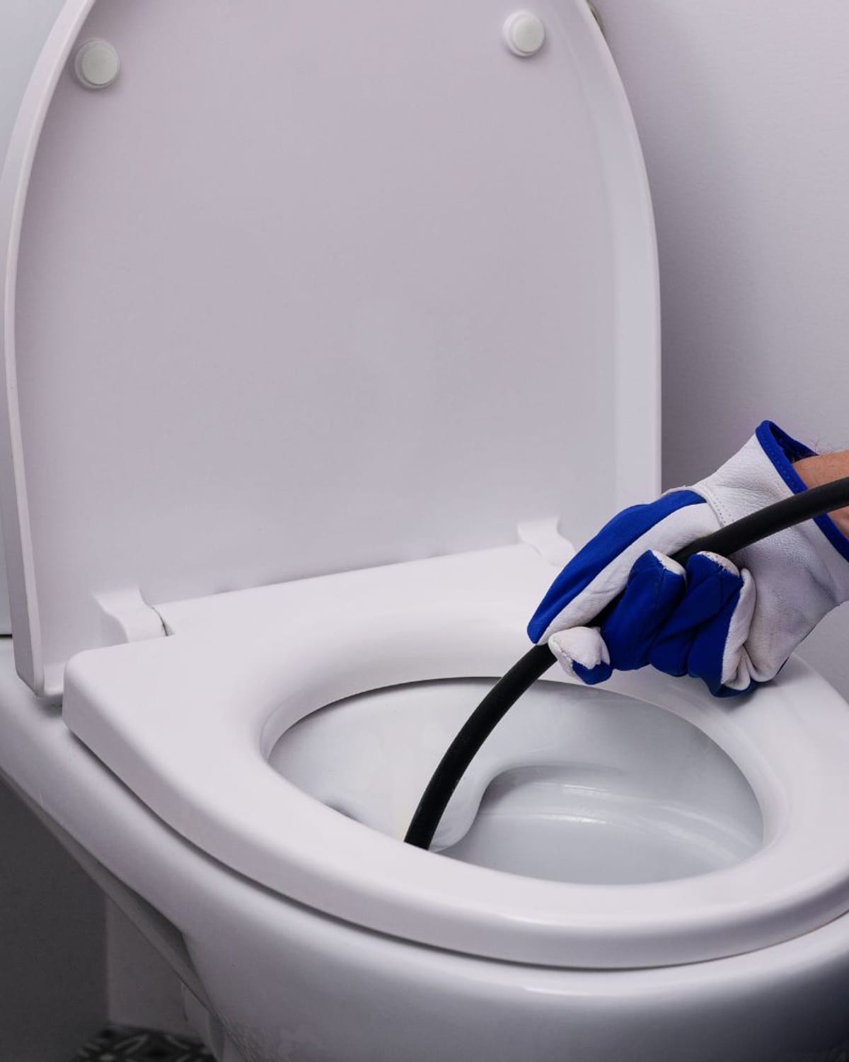 Auger clearing a stubborn toilet clog
