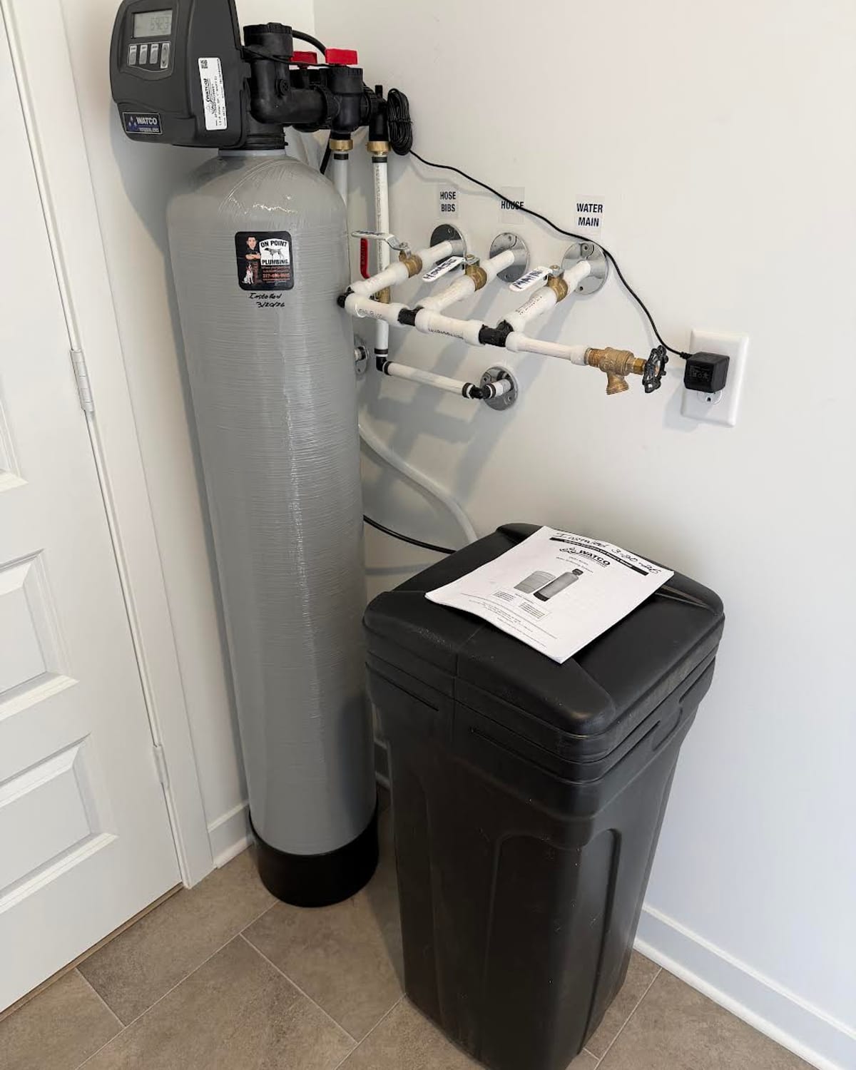 Completed water softener installation with brine tank in a Greenwood home